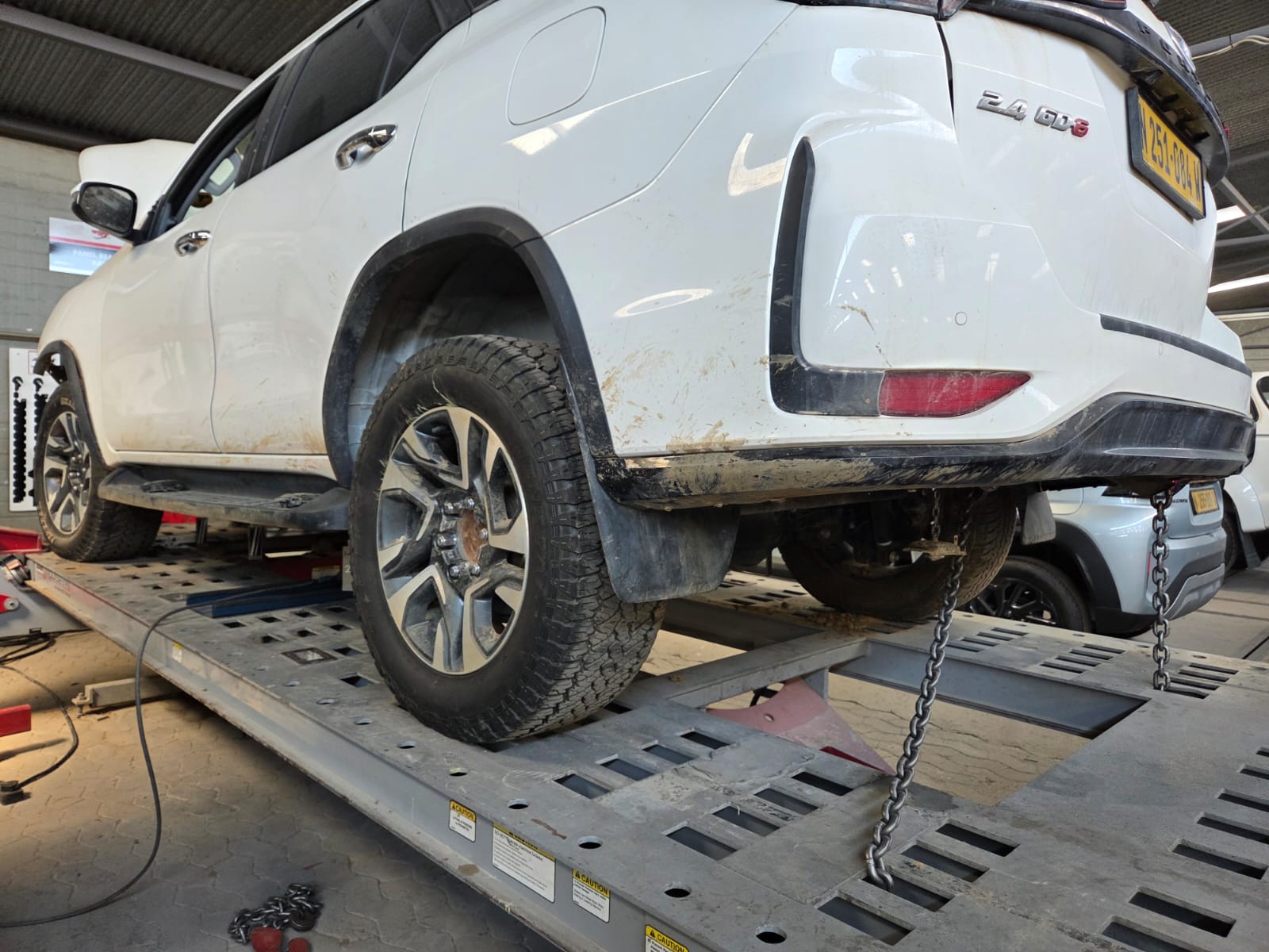 White Toyota Fortuner positioned on Genesis laser measuring equipment